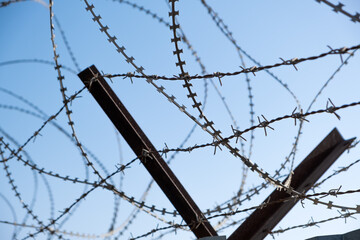 Barbed wire against the sky.