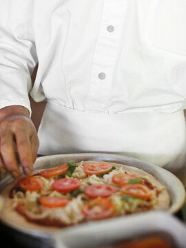 A chef makes a pizza. Yao Noi. Thailand.