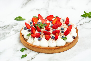 Delicious cake pie tart with fresh strawberries, raspberries, blueberry on white background. banner, menu, recipe place for text, top view