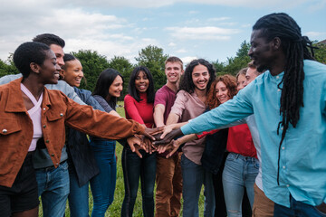 Multicultural group of young friends having a fun time together outdoors