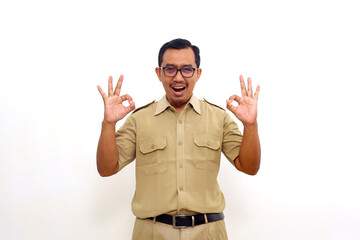 Satisfied Indonesian government employees standing while making okay hand gesture. Isolated on white