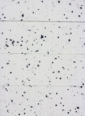 Styrofoam pile as background. White with black dots. Building material for thermal insulation of buildings. - 525675841
