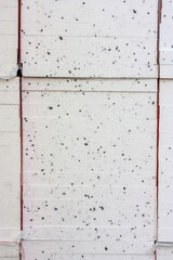 Styrofoam pile as background. White with black dots. Building material for thermal insulation of buildings. - 525675846
