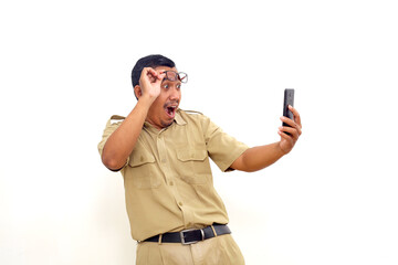 Wow and amazed expression of Indonesian government employees while holding cell phone.