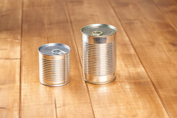 Iron tin can with tab opener on the wooden table.