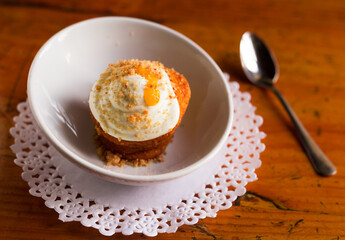 Homemade carrot cake with orange crumbs on plate close-up