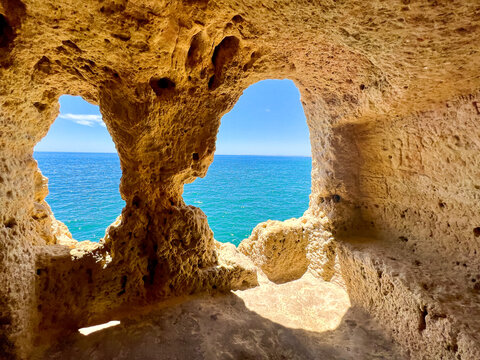 The Doll (A Boneca), the most famous viewpoint of Carvoeiro, two eroded archs with views out over the deep blues of the ocean. The natural caves exists in Algar Seco, Algarve - Portugal