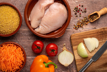 Food photography of raw Ingredients, chicken, bulgur, onion, paprika, carrot