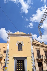 A small church with yellow walls in Partinico