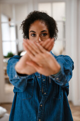Young black woman gesturing stop sign and protesting against abortion