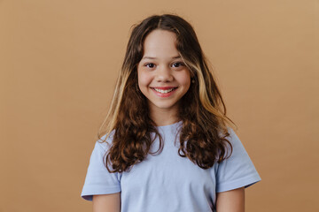 White preteen girl wearing t-shirt smiling and looking at camera