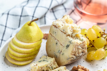 Piece of French Blue cheese grapes, honey and pear for dessert, Food recipe background. Close up