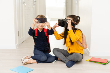 New program. Clever progressive schoolgirl visiting IT courses and touching the screen with two hands while wearing virtual reality glasses