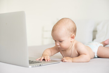 Baby with laptop on the white background