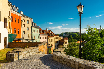 Fototapeta na wymiar Lublin, Lubelskie Voivodeship / Poland - July 10 2022: tenement houses in Lublin old town illuminated by the morning sun.