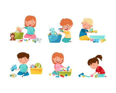 Cute little boys and girls cleaning up his toys and putting toys into boxes set cartoon vector illustration