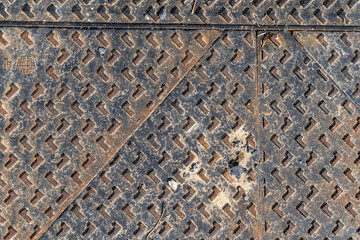 metal manhole cover with pebbles