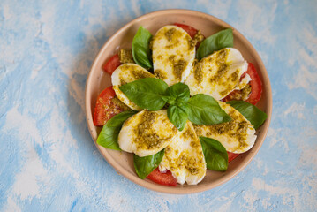 delicious italian caprese dish with mozzarella tomatoes and pesto sauce