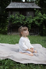 child sitting on the grass in sibiu romania 