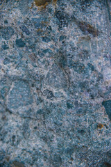 Stone gray-blue textured background. Natural stone. The background is a blank for the design. Uneven surface.