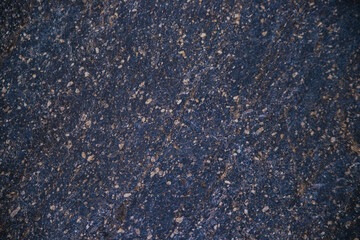 Stone black textured background. Natural stone. The black background is a blank for the design. Uneven surface.