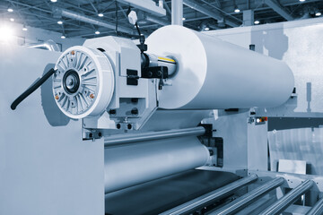 The operation of automatic plastic packaging production machine. roller of the polyethylene packaging production machine.  machine for packaging with cellophane