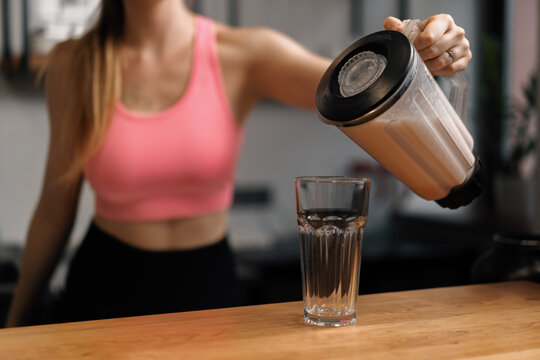 Curvy women make a protein shake at the fitness health bar in the gym