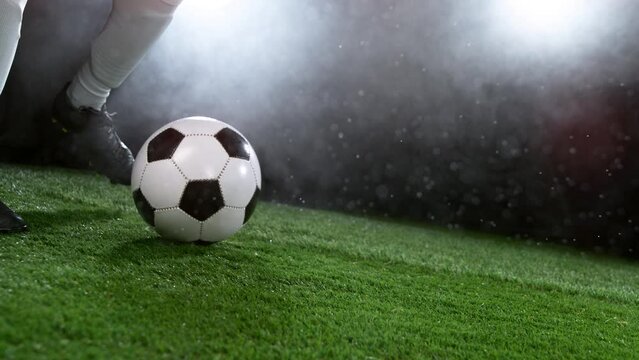 Close-up of Football Player Kicking Soccer Ball, Super Slow Motion at 1000 fps. Filmed on High Speed Cinematic Camera.