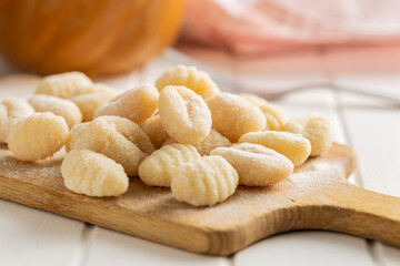 Uncooked potato gnocchi on cutting board. Tasty italian food.