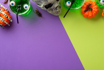Halloween party concept. Top view photo of glasses floating eyeball punch scull skeleton hand holding pumpkin spiders centipede cockroach on bicolor violet and light green background with copyspace