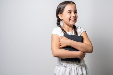 Brunette little girl reading a book isolated on a over white background