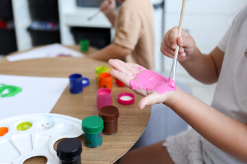 Children's drawing workshop, happy children make handprints with paint