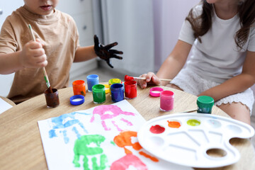 Children's drawing workshop, happy children make handprints with paint