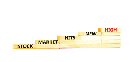 Stock market hits new high symbol. Concept words Stock market hits new high on wooden blocks on a beautiful white table white background. Business and stock market hits new high concept. Copy space.