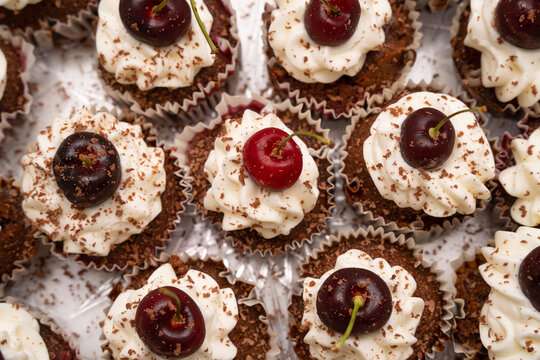Chocolate Cupcakes with Cream and Cherries