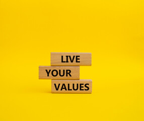Live your values symbol. Concept words 'Live your values' on wooden blocks. Beautiful yellow background. Business and Live your values concept. Copy space.