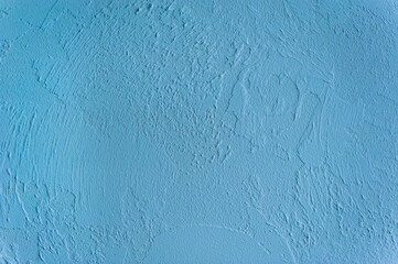 Background, texture of uneven surface in blue wall paint.
