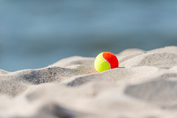 Beach tennis ball on the sandy beach. Summer sport concept. Horizontal sport theme poster, greeting cards, headers, website and app