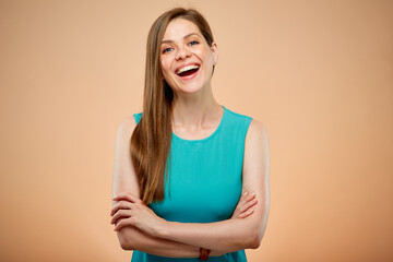 Obraz premium Smiling woman with arms crossed isolated portrait on yellow brown background.