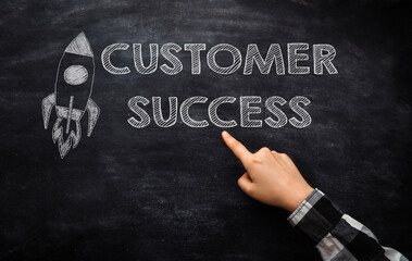 Person points to phrase Customer Success on blackboard