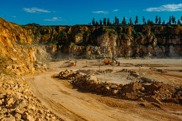 Excavarors working on limestone mining in the quarry