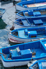 Fototapeta na wymiar Blue boats abstract composition background. Gallipoli, Puglia, Italy
