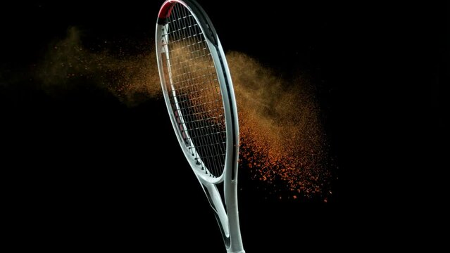 Super Slow Motion Shot of Racket Hitting Tenis Ball Containing White Powder at 1000 fps.
