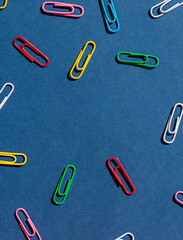 Colorful paper clips frame on the blue background seamless pattern. Copy space