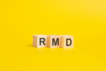 wooden blocks with word RMD on yellow paper. business concept