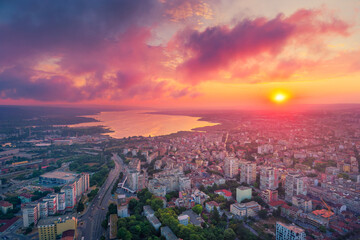 Dramatic sunset over Varna city and Varna lake, Bulgaria. Scenic aerial view landscape.