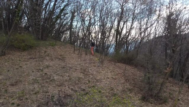 Hiker climbing the stairs in the woods of Colli Asolani, Asolo, Italy