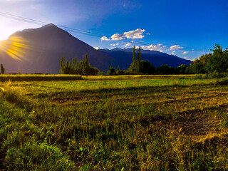 Beautiful view of field with mountains and fresh sky.