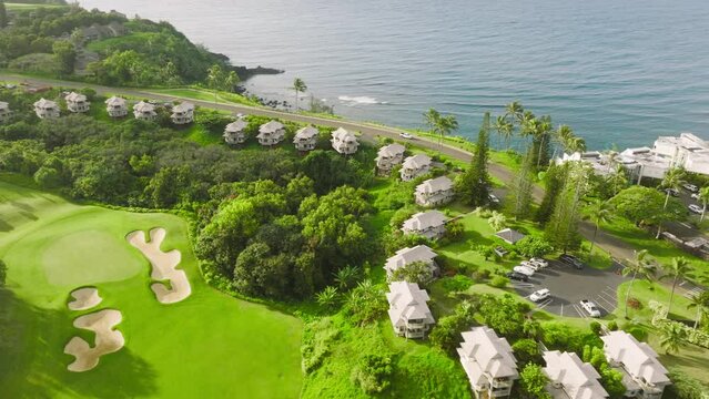 Charming town along lavish vast terrain, washed by the Pacific Ocean. Drone overlook above idyllic and peaceful tropical landscape within Hanalei Valley, Hawaii, USA. High quality 4k footage