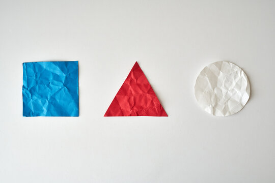 Red, White and Blue Paper Shapes on light background	
